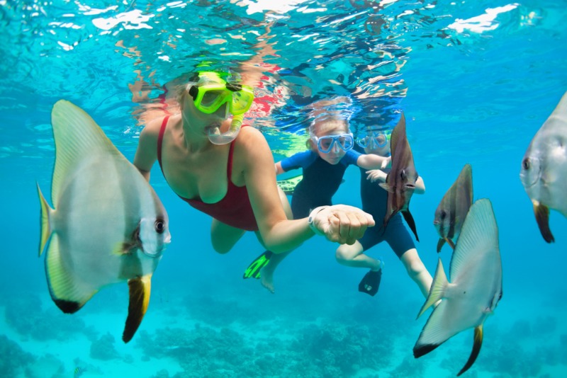 Maui Snorkeling: A mother and her young son explore a tropical reef off the West Maui coast.
